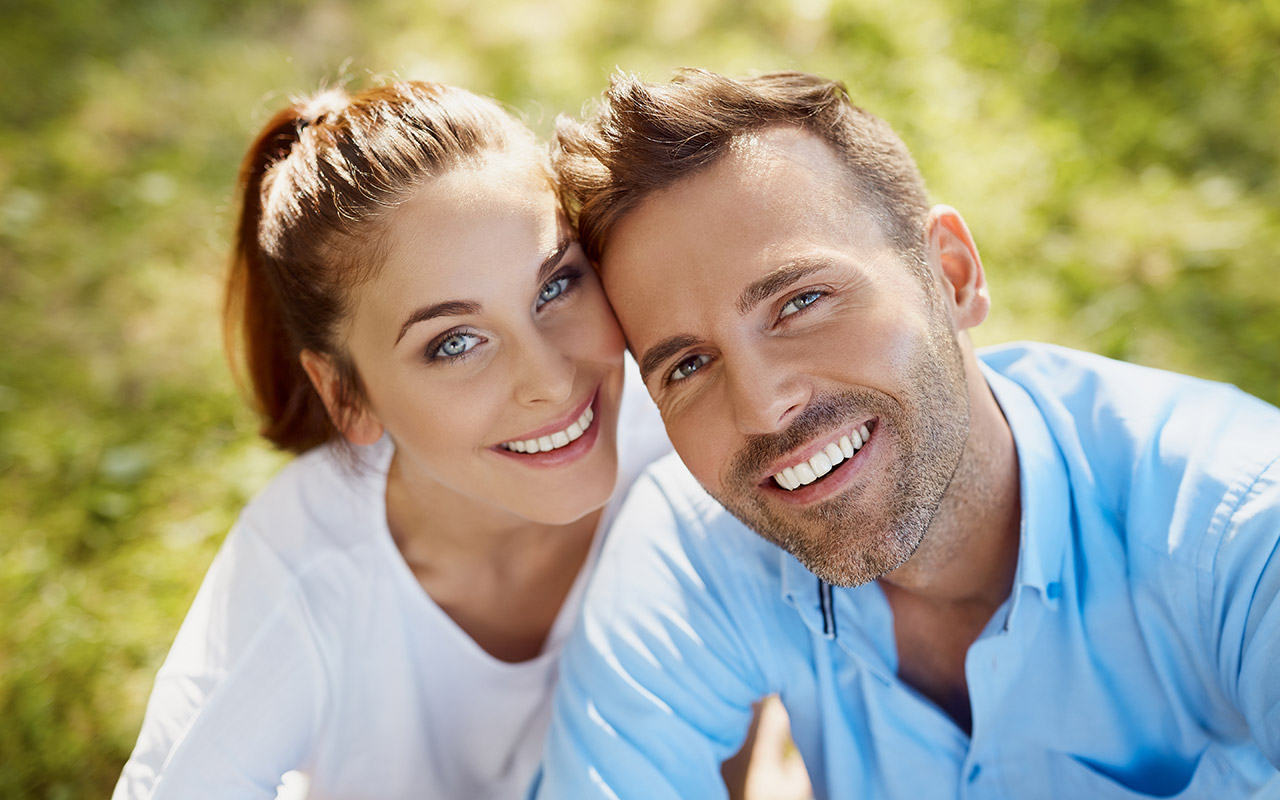 Very Handsome Couple Smiling At Camera After Cosmetic Dentistry